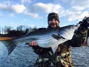 Aaron with a best of a Boone Lake striper while fishing with Charlie