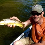 Clint with a Watauga river brown trout while fishing with Huck