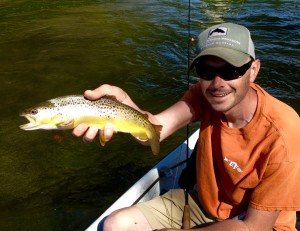 Clint with a Watauga river brown trout while fishing with Huck